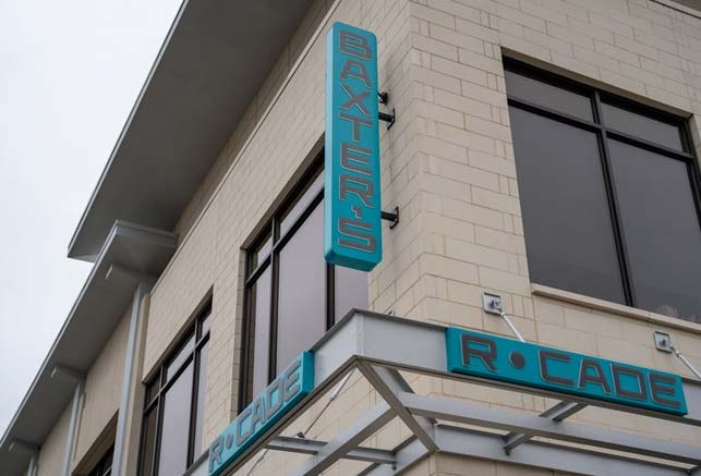 A building with signs reading Baxters and R•Cade, featured in 15317 Lifestyle Publication.