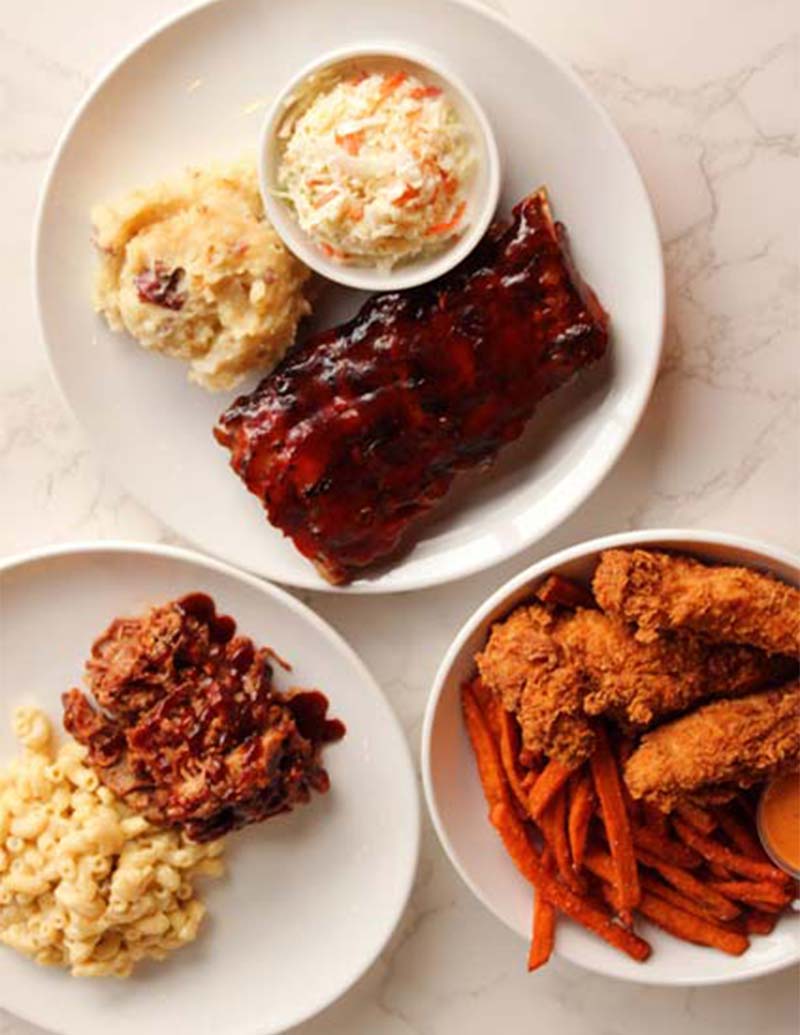 Three plates of barbecue ribs, fried chicken, and sides featured in Southpointe PA Magazine.