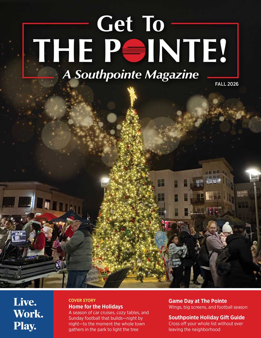 A crowd gathers in a plaza at night, featured in Southpointe Community Magazine Issues.